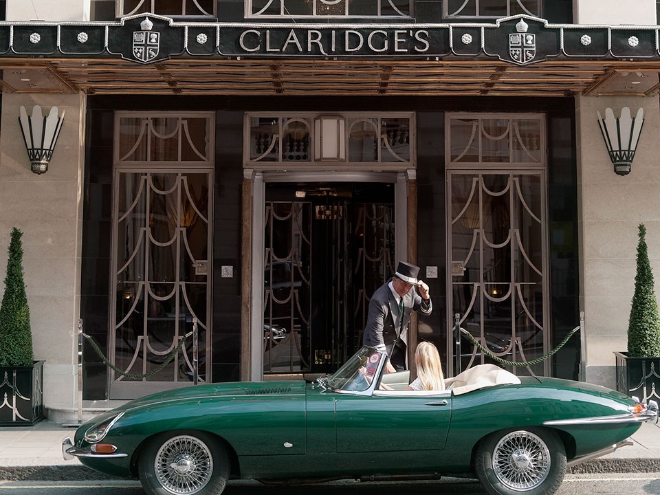 Claridge's hotel exterior with car outside and doorman greeting guest