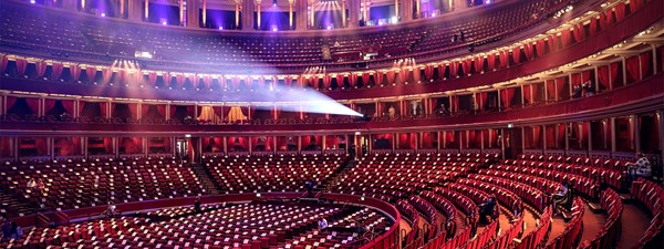 A panoramic view of a large red velvet seats of a round theatre