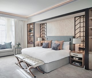 A view of a King Bed and a bedroom in a classic interior with Art Deco elements, in pastel colours of design.