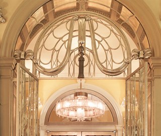 Chandeliers and gold ornaments from the Art Deco era can be seen at Claridge's Hotel.