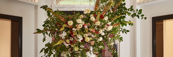 dramatic display of Claridge's flowers, located outside the ballroom with the iconic Claridge's logo in the background.