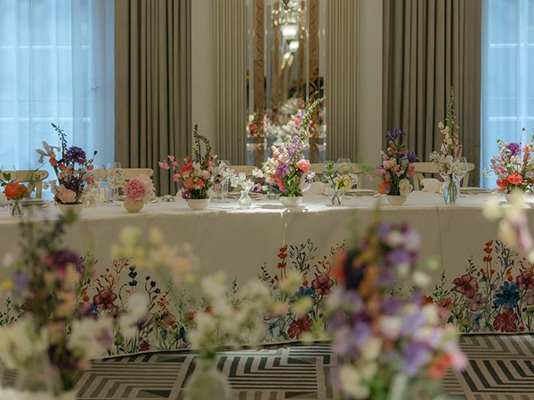 Vibrant flower displays on a round table in the ballroom