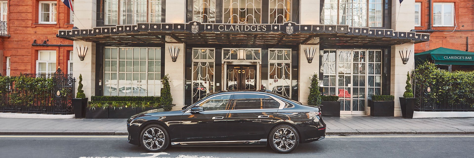 Exterior of Claridge's hotel with car fleet parked outside the entrance