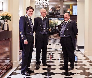 Photo of smiling concierge and The Hotel Ambassador, Martin Ballard, in the corridor of Claridge's Hotel.
