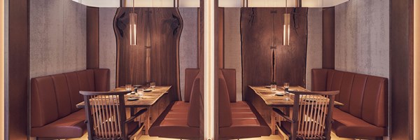 View of two tables with  a booth at the Connaught Grill, with wooden tables and wooden surroundings